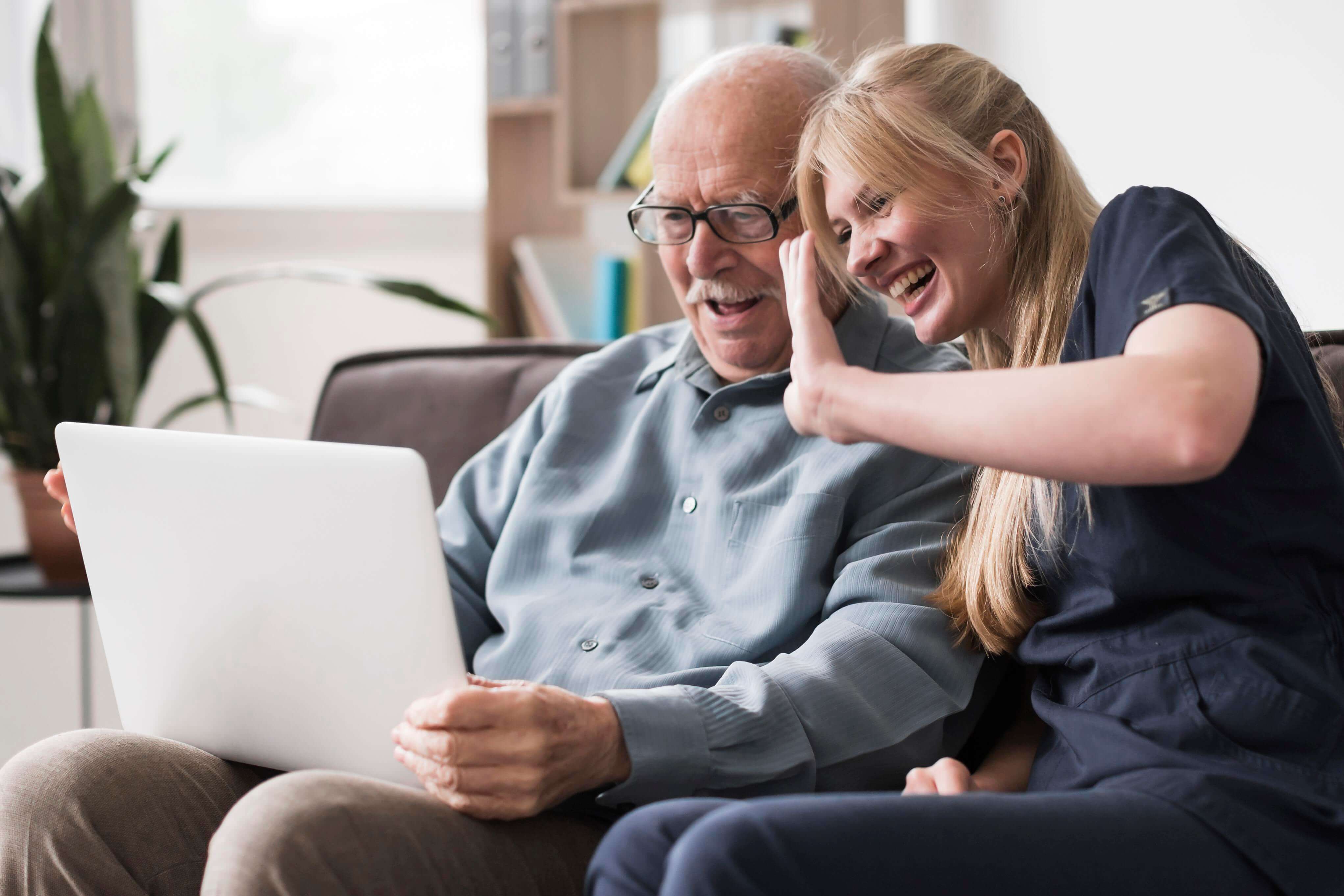 smiley-old-man-nurse-having-video-call-laptop (1)